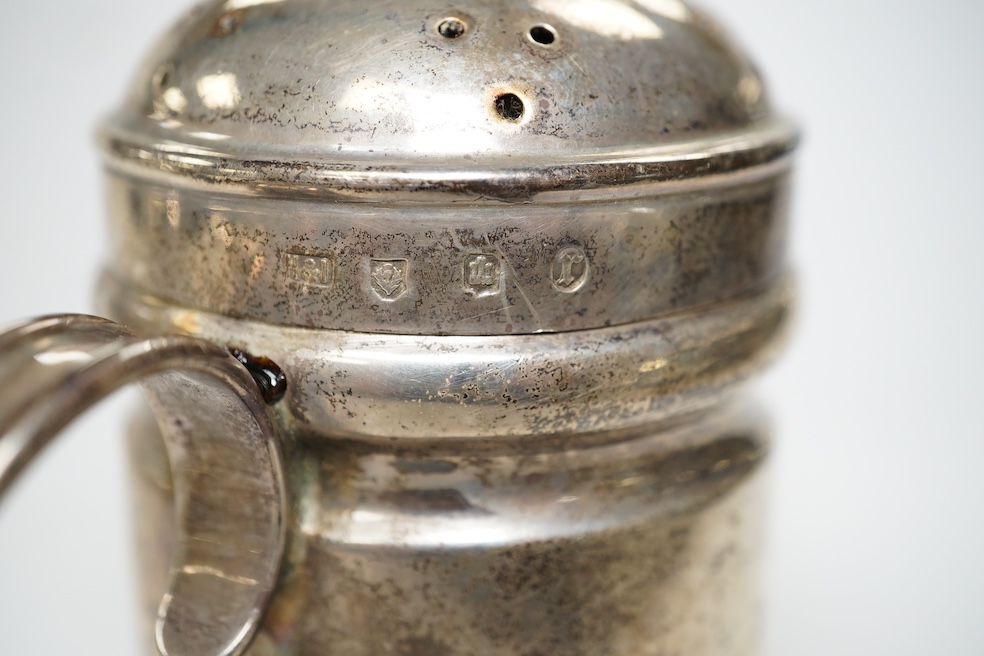 A late Victorian silver Guernsey milk can, marks rubbed, 14cm, a small silver mug and a Scottish silver kitchen pepper, Hamilton & Inches, Edinburgh, 1898, gross weight 16.4 oz. Condition - poor to fair